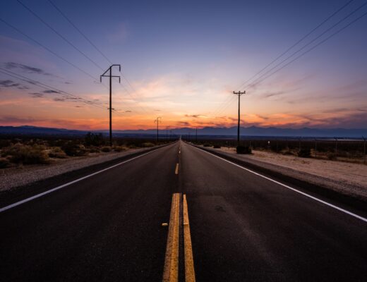 A road with powerlines through Death Valley National Park